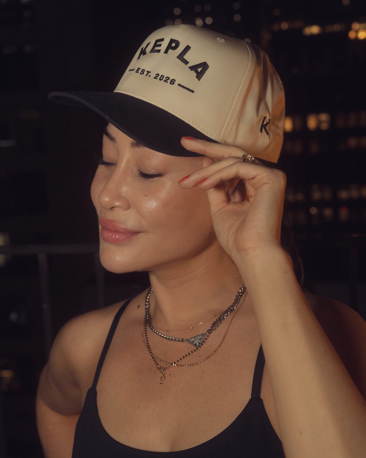 Close up of the Kepla hat: KEPLA EST. 2026 embroidered front and the K monogram on the side panel