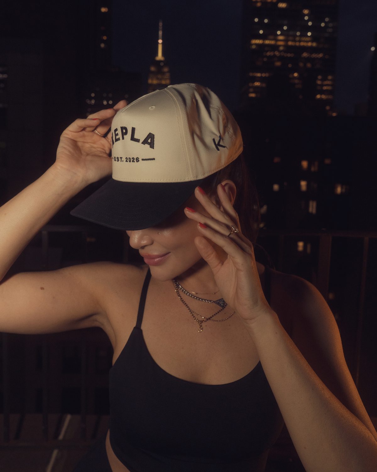 Kepla hat worn brim down at night with the Empire State Building lit in the background